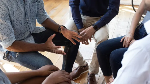 African man counselor speak at group counseling therapy session African man counselor speak at group counseling therapy session