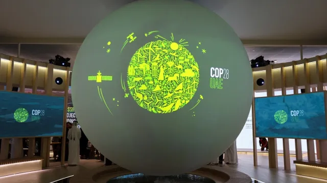 A view shows the 'Cop28 UAE' logo on a globe, during Abu Dhabi Sustainability Week (ADSW), in Abu Dhabi